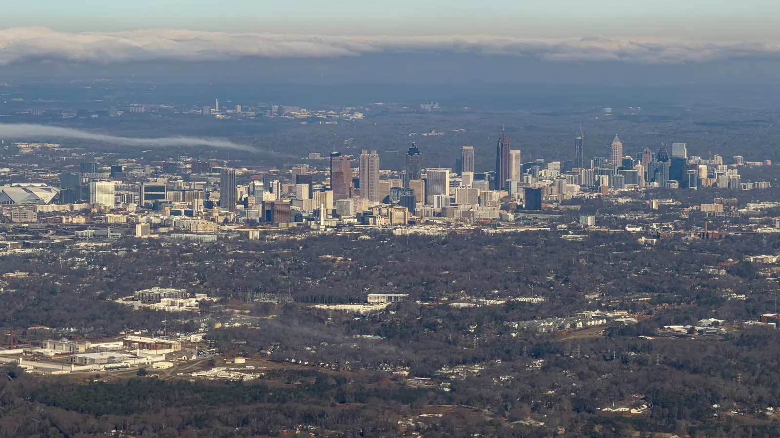 Stock photo: an aerial view of downtown Atlanta and nearby neighborhoods under low cloud.