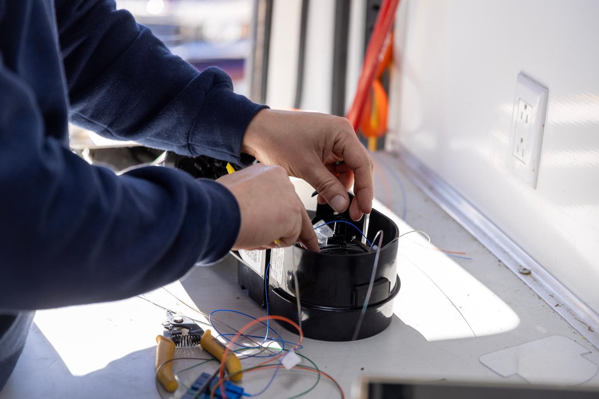 Close-up of precision fiber optic splicing by a Norvet MSP technician