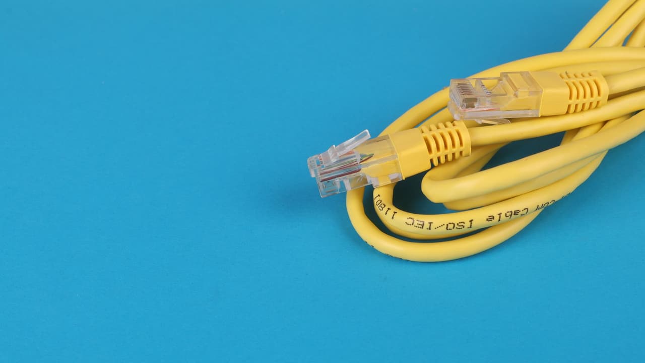 Stock photo: a yellow Ethernet cable with its plug in close-up.