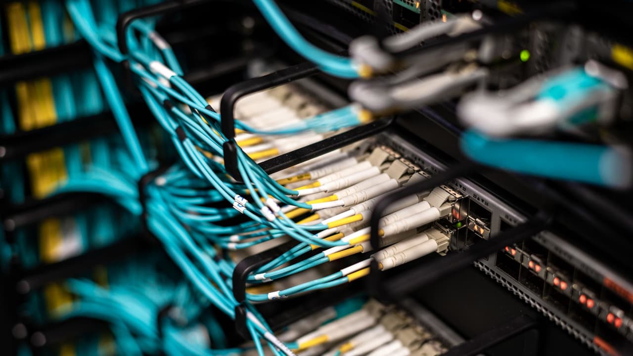 Stock photo: many cables mounted into a network rack.
